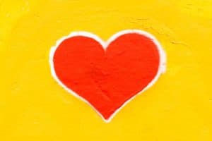 Hand painted image of a heart with yellow background