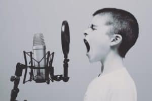 child singing on the microphone